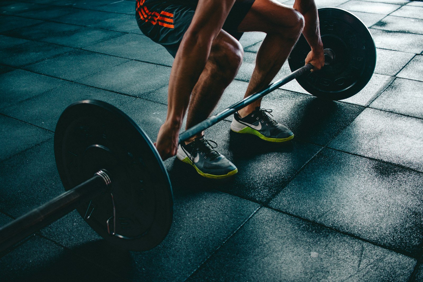 People training with free weights in a bright gym